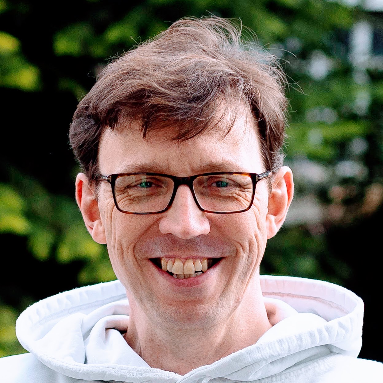 Adam Hardy, head shot with white hoodie